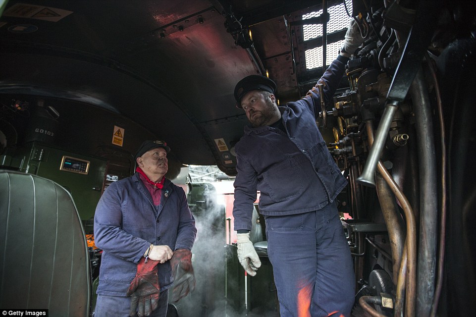 318A985C00000578-3464245-Tough_graft_The_crew_work_inside_the_engine_room_of_the_train_wh-a-55_1456426654425